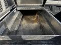 An empty metallic storage box in the bed of a 2017 Ford F-150