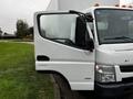 A 2012 Mitsubishi Fuso FE truck with an open driver's side door and a white exterior