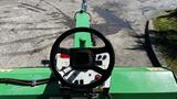 A green Laymor SweepMaster 300 with a steering wheel and control panel visible from the operator's perspective