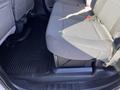 A 2019 Ford F-350 SD with gray fabric seats in the back row featuring a spacious seating area and a black rubber floor mat beneath