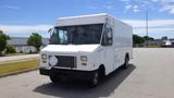 A white 2011 Ford Econoline box truck with a flat front and large windshield parked with a covered grill and no visible brand markings