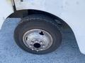 Close-up of a tire mounted on a 2008 Ford Econoline showing a silver wheel and a rugged tread pattern