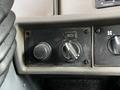 Close-up of a control panel in a 2014 Kenworth T370 featuring knobs for air suspension and other settings
