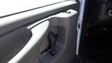 Interior door handle and control panel of a 2012 GMC Savana van with a gray finish and a button for window operation