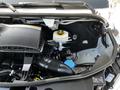 A 2022 Mercedes-Benz Sprinter engine compartment showcasing various engine components including the air intake and fluid reservoirs