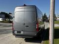 A 2021 Mercedes-Benz Sprinter van parked on the side of the road with a silver exterior and rear doors closed