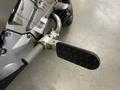 Footpeg of a 2013 BMW K1600GTL motorcycle showing a textured surface and sturdy metal support system