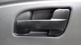 Interior door handle of a 2010 International 4300 in black plastic with a textured grip