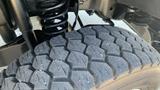 Close-up of a rugged tire from a 2011 Ford F-450 SD showcasing a deep tread pattern for enhanced traction and durability