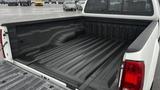 The image shows the bed of a 2016 Nissan Frontier truck with a textured black liner and no cargo inside