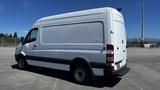 A 2016 Mercedes-Benz Sprinter van painted white with a high roof and sliding side door displaying a simple design and black accents on the wheels