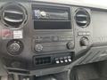 Dashboard of a 2011 Ford F-250 SD featuring a radio display various knobs and buttons for controls