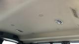 Interior view of the ceiling of a 2017 Chevrolet Express Quigley 4x4 featuring light fixtures and vent openings