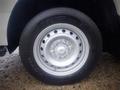 A close-up of a wheel from a 2003 Toyota Toyoace featuring a silver rim with multiple holes and a black tire with the brand name Toyo