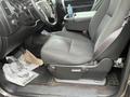 Interior view of a 2013 Chevrolet Silverado Hybrid showcasing the driver's seat center console and floor mats