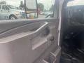 Interior view of a 2017 Chevrolet Express highlighting the driver's side door panel and control features