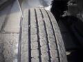 A close-up of a worn tire tread on a vehicle showing distinct grooves and wear patterns of a 2007 Ford F-650