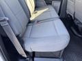 The interior of a 2019 Ford F-350 SD showing the rear bench seat with light gray upholstery and seat belts