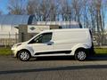 A 2022 Ford Transit Connect van in white with a silver trim parked on a pavement