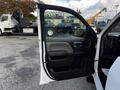 The interior door of a 2017 GMC Sierra 1500 is open displaying the door panel and controls for windows and locks