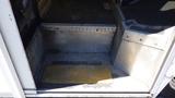 2006 Ford Econoline door step leading into the vehicle with a textured metal surface and a yellow entry mat