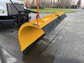 A yellow snow plow attached to a 2006 Freightliner M2 106 vehicle ready for snow removal