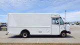 A white 2011 Ford Econoline delivery van with a long cargo area and a passenger side door