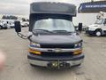 Front view of a 2018 Chevrolet Express with a large passenger cabin and distinctive Chevy grille