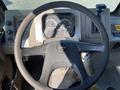 Dashboard and steering wheel of a 2010 Freightliner MT45 Garbage Truck displaying gauges and controls