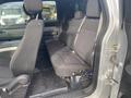 Interior view of a 2014 Ford F-150 showing the back seat with black fabric upholstery and seat belts