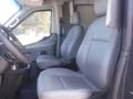 Interior view of a 2016 Ford Transit showing two gray front seats and a steering wheel