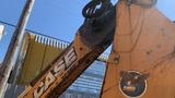 A 2015 Case 580 backhoe loader with a yellow and black exterior featuring the Case logo and an eagle design on the side