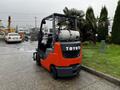 A red and black 2017 Toyota 8FCGCU25 forklift with a gas cylinder attached at the back