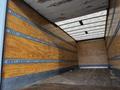 Interior view of a 2022 Ford F-750 cargo truck with wooden walls and a metal floor showing ample space for storage or transport