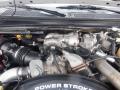 Close-up of a 2009 Ford F-450 SD engine showing the turbocharger intake manifold and various components including hoses and filters