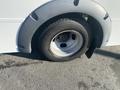 A close-up view of a wheel on a 2018 Chevrolet Express featuring a gray fender and a black tire with visible tread