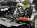 Close-up view of the engine of a 2020 Hino 338 showcasing various mechanical components including hoses wires and a prominent red intake pipe