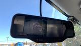 A 2013 Ford Econoline viewed through a rearview mirror displaying the vehicle's interior