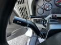 A close-up view of the turn signal and wiper control stalk in a 2011 International 7300 vehicle's interior