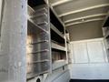A 2019 Ford F-350 SD with metal shelving units and open storage compartments in the cargo area
