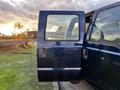 A 2008 Ford F-250 SD with the passenger door open showing the interior and side mirror