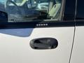 A white 2013 Ford Expedition with a black door handle and keyless entry keypad on the driver's side door