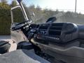 The interior of a 2020 Hino 195 featuring the dashboard with various controls a steering wheel and a comfortable driver's seat