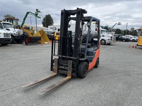 A 2011 Toyota Forklift with an orange and black color scheme featuring two metal forks at the front and seating for an operator