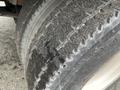 Close-up of a tire from a 2007 International 4300 showing tread wear and dirt buildup on the surface