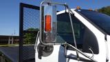 Close-up of a 2006 Ford F-650 side mirror with an orange indicator light and chrome detailing extending from the truck's cab