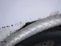 The image shows a close-up of a 2010 Forest River Enclosed trailer with visible corrosion on the metal surface and a diamond plate trim near the tire