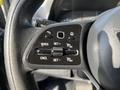 Close-up of a steering wheel control panel from a 2021 Mercedes-Benz Sprinter featuring buttons for cruise control settings and adjustments