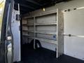 Interior of a 2021 Mercedes-Benz Sprinter van featuring metal shelving units along the sides designed for storage and organization
