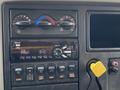 Dashboard of a 2018 International 26 Foot Cube featuring climate control knobs a Bluetooth stereo and various control buttons